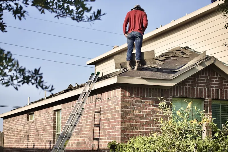 Professional roofer working on a residential roof in Woodside